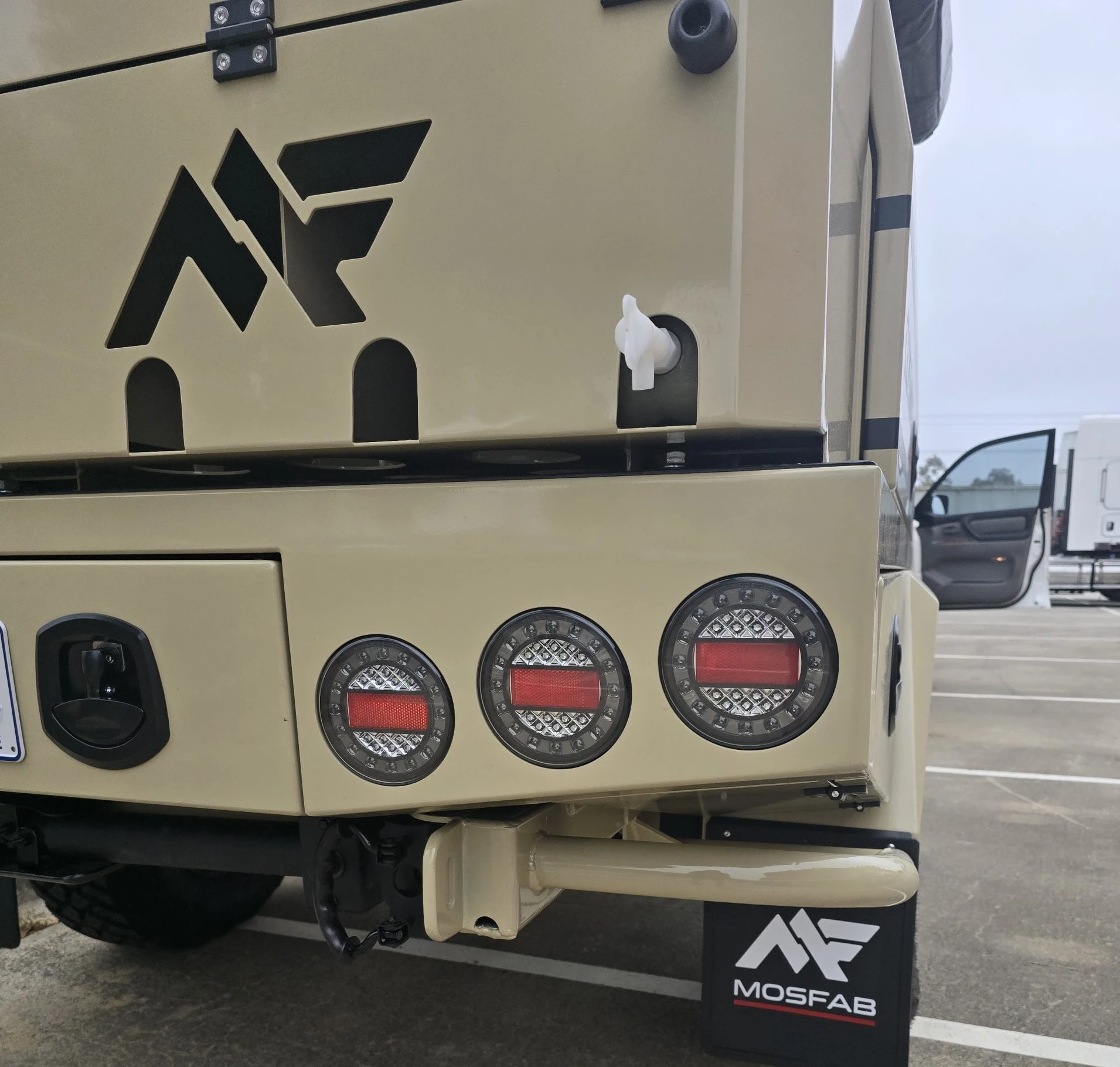 The jerry can box at the rear includes cutouts for running a water faucet through – you probably don't want to do that on the drive there, but once at camp, it makes for a convenient place to rinse one's hands and fill up water