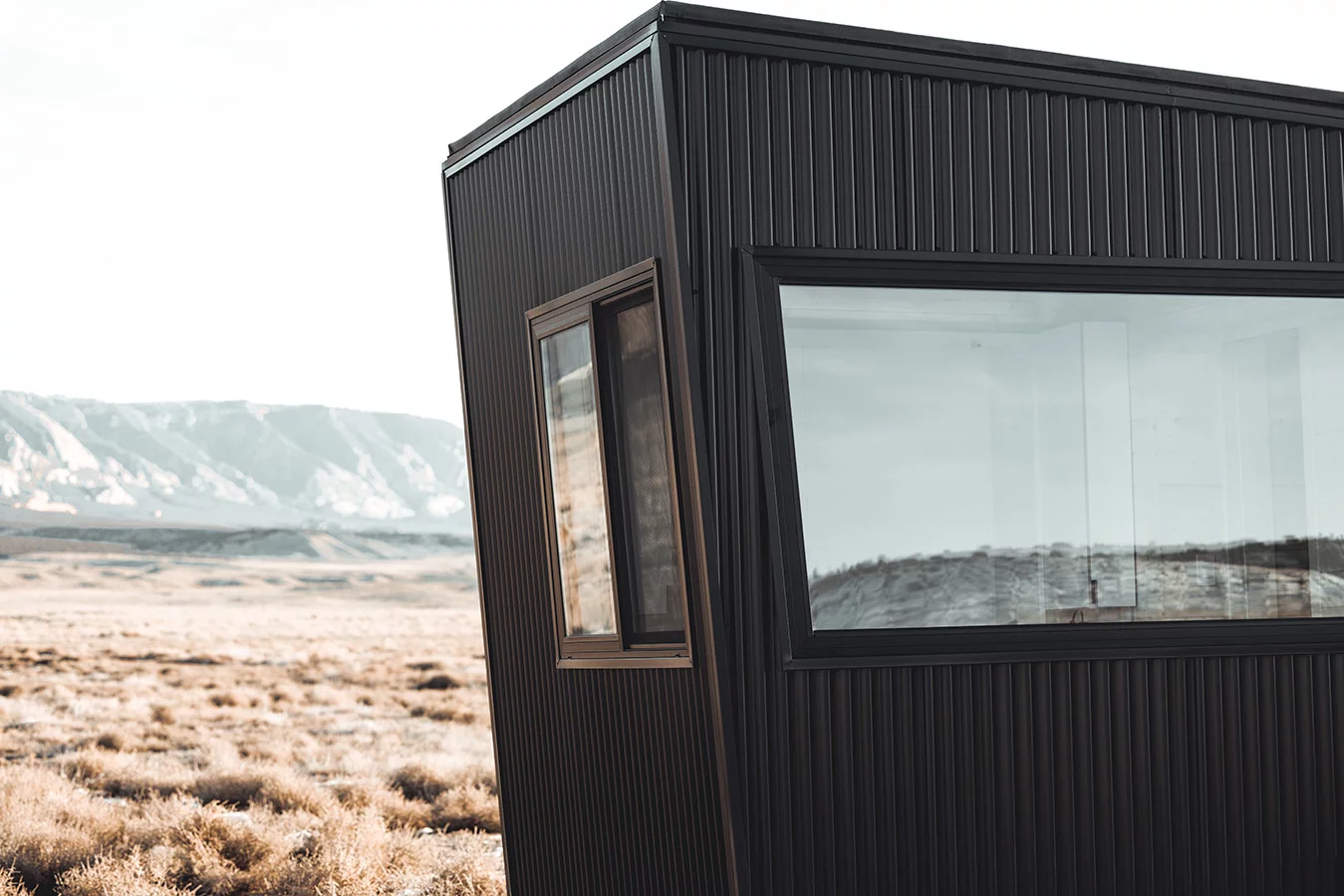 The Quatro's name is inspired by its windows, which are at exterior is finished in black corrugated metal and the tiny house also features generous glazing