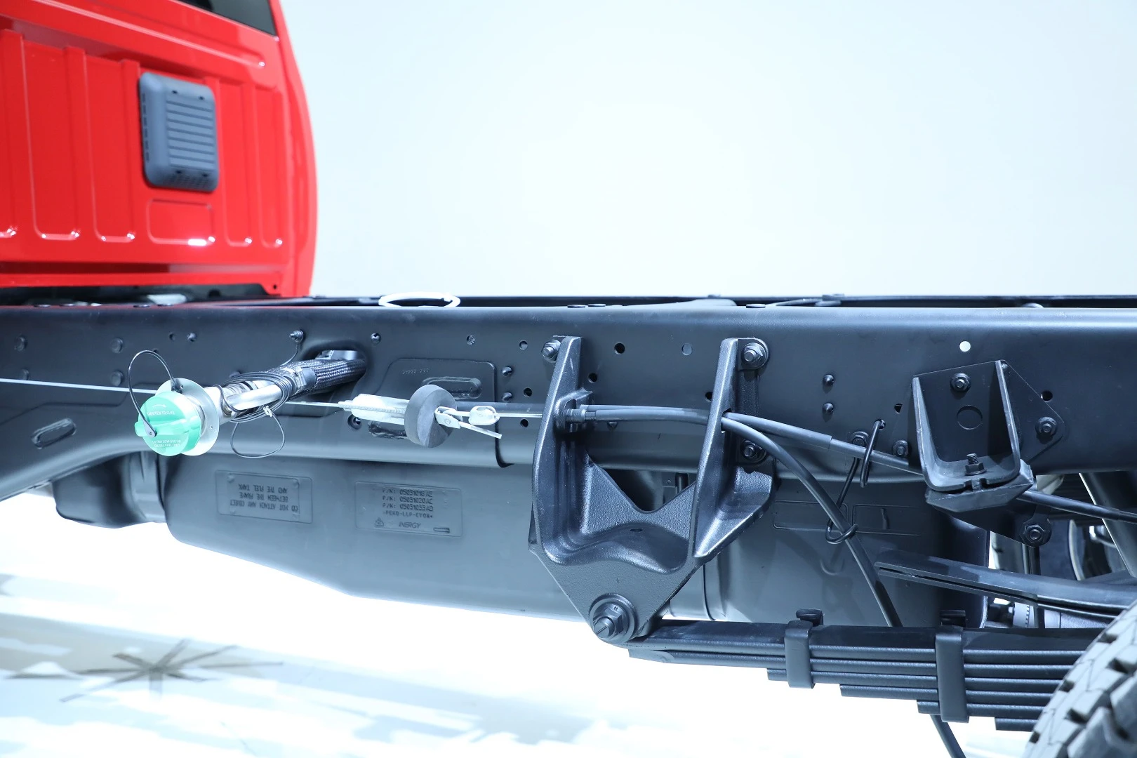 Fuel tanks and filling hoses are kept below the top of the framing for protection after specialty equipment is installed atop the frame