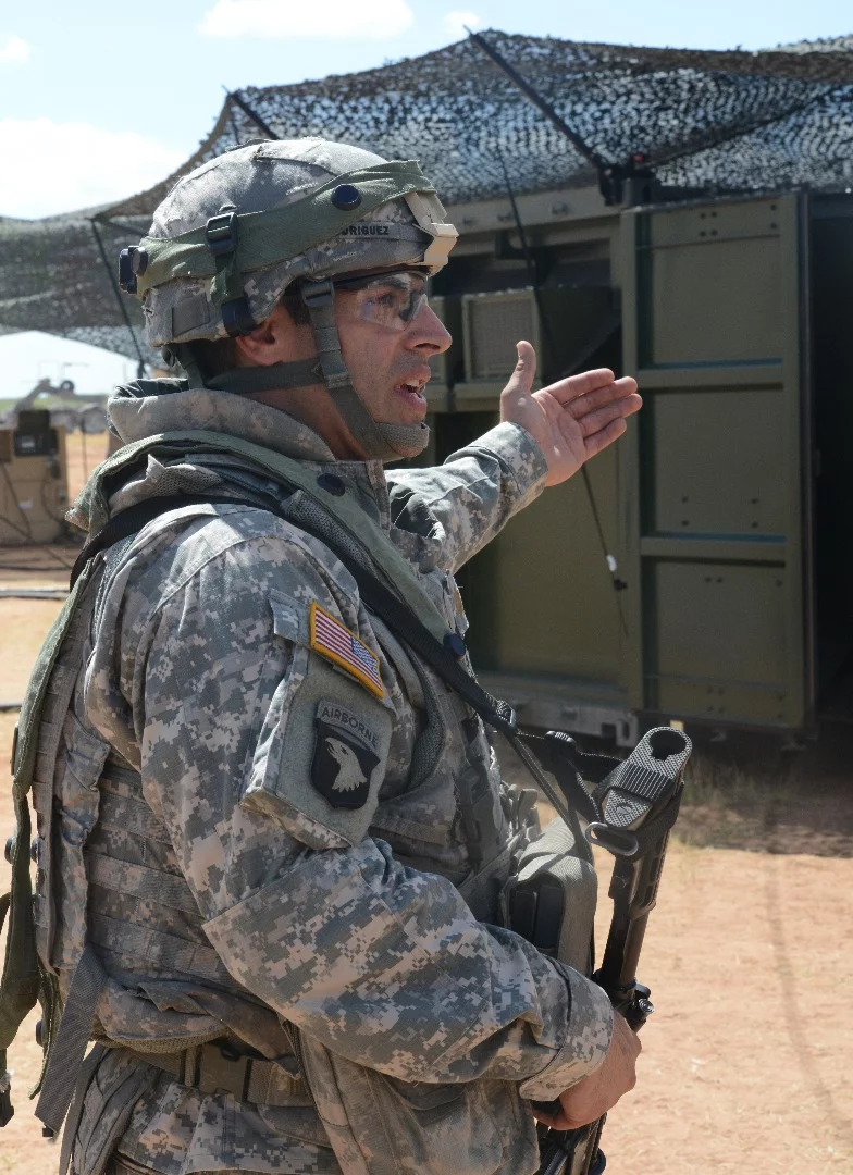 Major Daniel Rodriguez, company commander, 542nd Quartermaster Company, a Reserve unit out of Erie, Pennsylvania, points out his Force Provider System air-conditioned living and working quarters