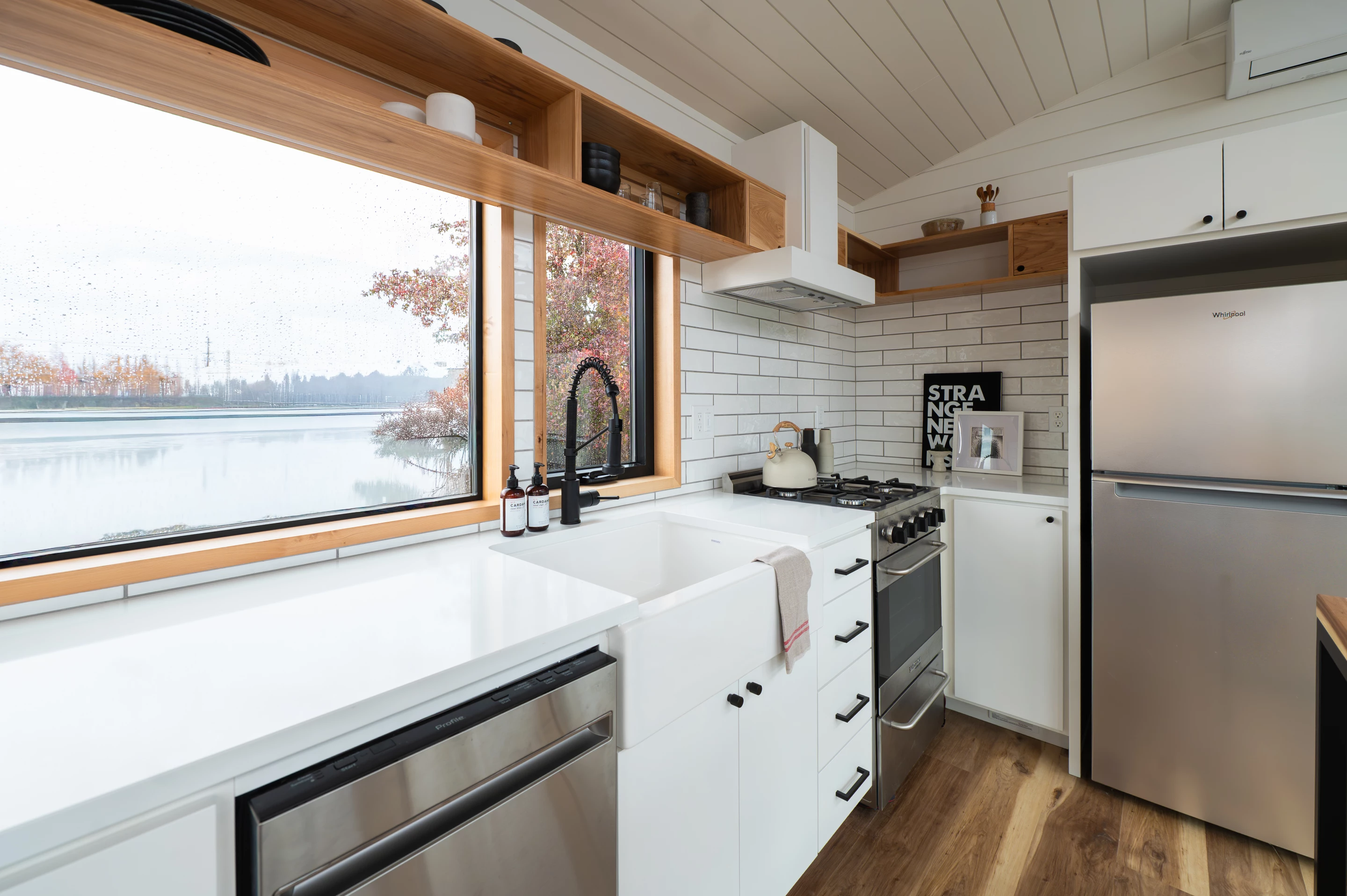 The Urban Park Max 37's kitchen has a fridge/freezer, a sink, a dishwasher, and an oven and four-burner propane-powered stove