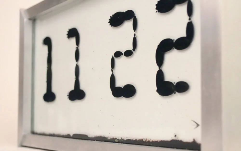 Ferrolic is a clock which tells the time by manipulating ferrofluid using electromagnets