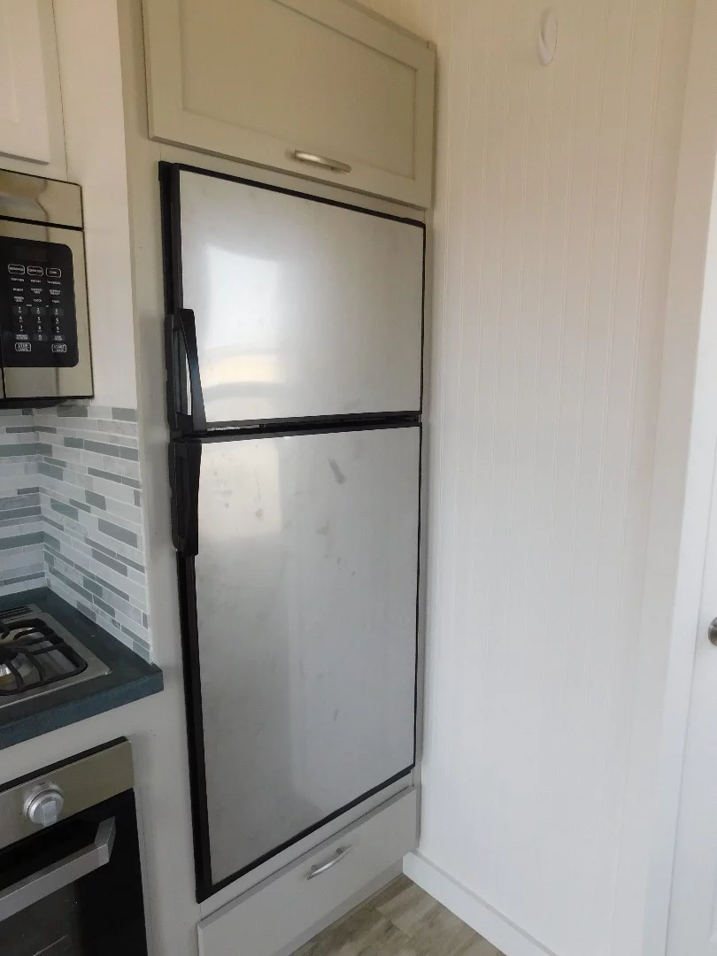 The Ozark's kitchen also includes a stainless steel fridge