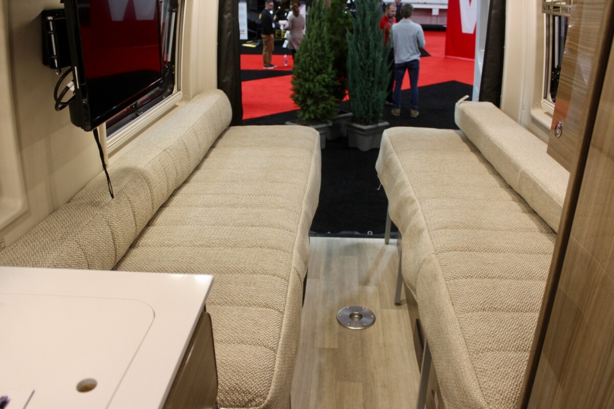 The versatile rear bed of the Q70 BL floor plan works as a pair of sofas, two twin beds or a single queen-size bed