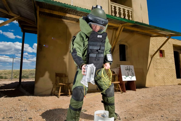 Airman 1st Class Patrick Connolly of Dayton, Ohio, demonstrates the placement of the water disruptor in a simulated village used to train soldiers heading overseas (Image: by Randy Montoya)
