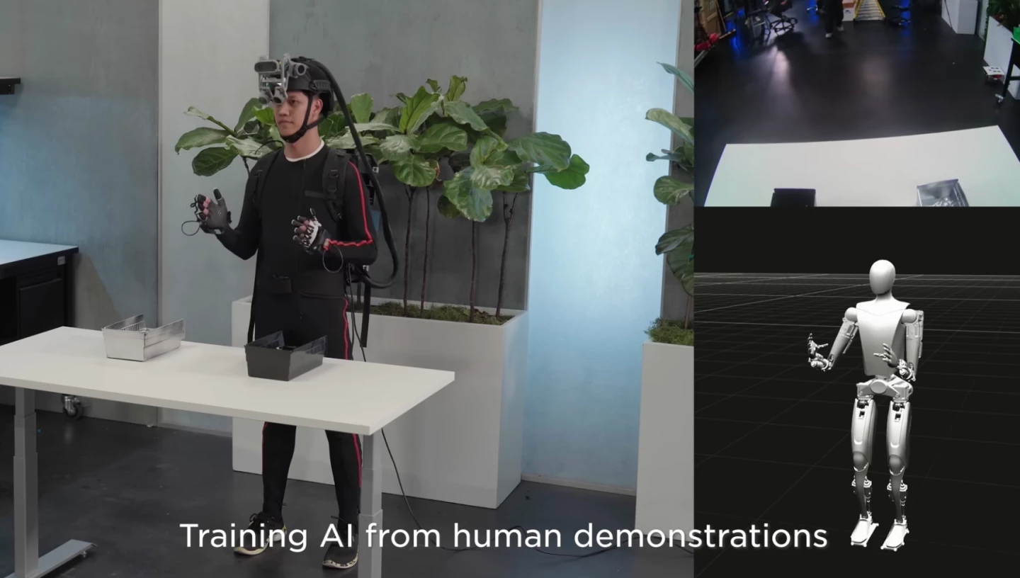 Human operators in motion capture suits are performing basic tasks, in order to train the bots