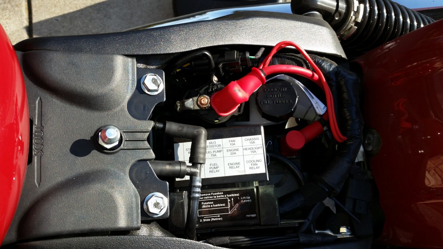 Access to the battery and filler cap for the coolant is directly under the seat