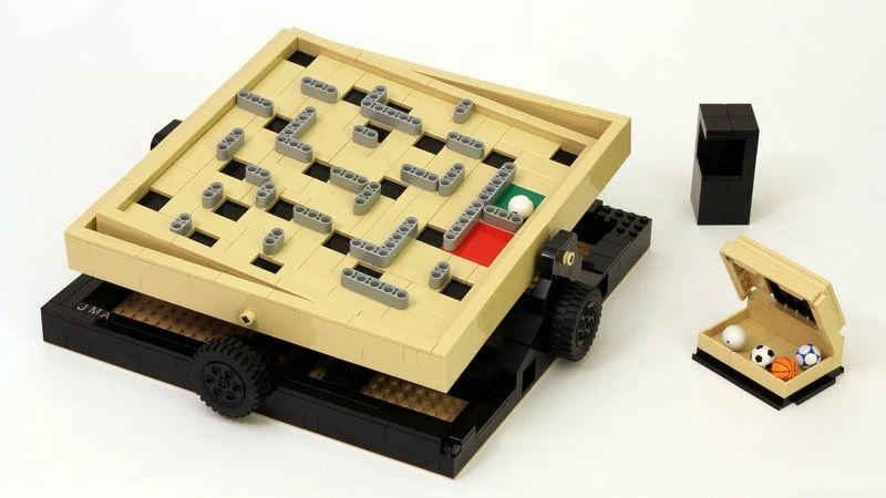 The Labyrinth Marble Maze idea comprises a base with simple tilting mechanisms made of axles and beams that are operated using two wheels
