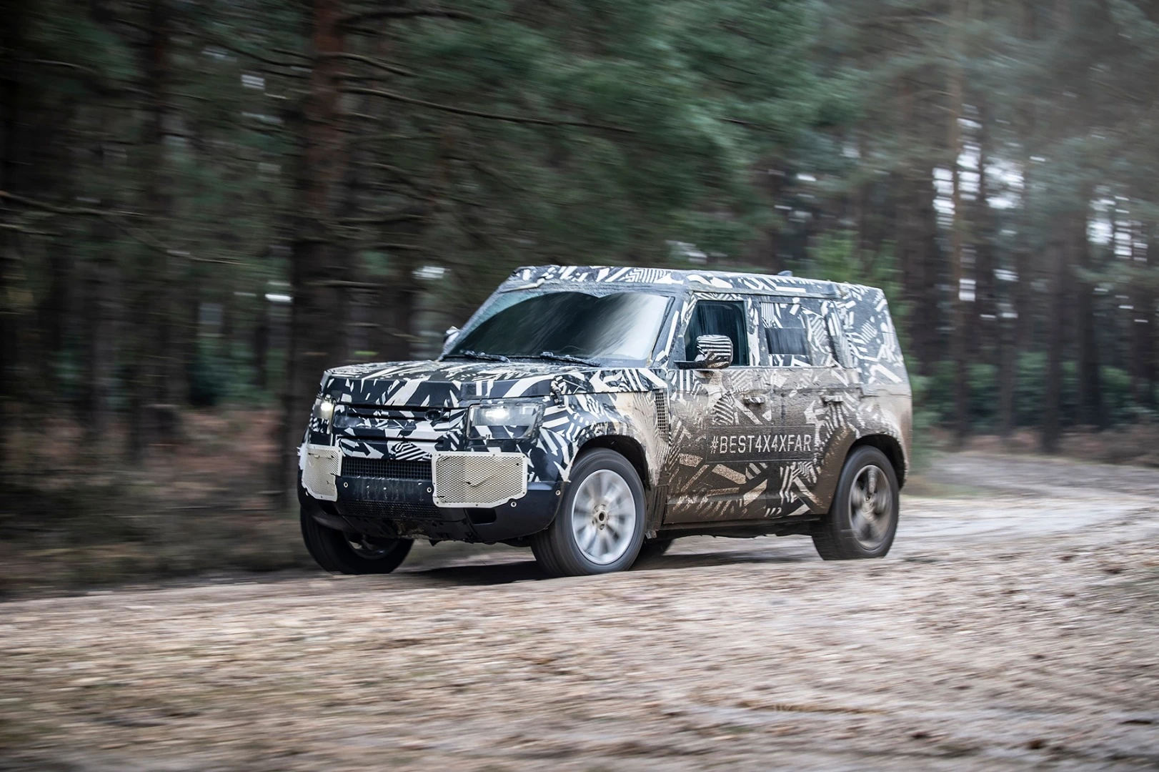 The prototype Land Rover Defender battling the mud of Eastnor, UK