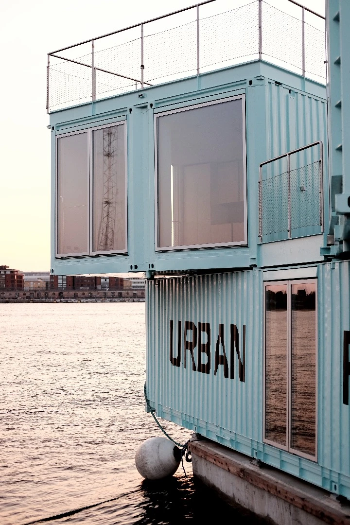 The nine containers are stacked atop each other and rest on a floating base