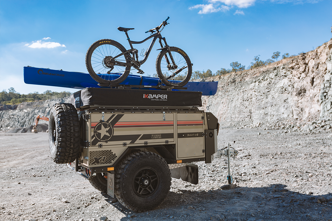 The iKamper X-Cover has crossbars integrated on its lid, so you don't have to choose between carrying bikes or a tent on the trailer