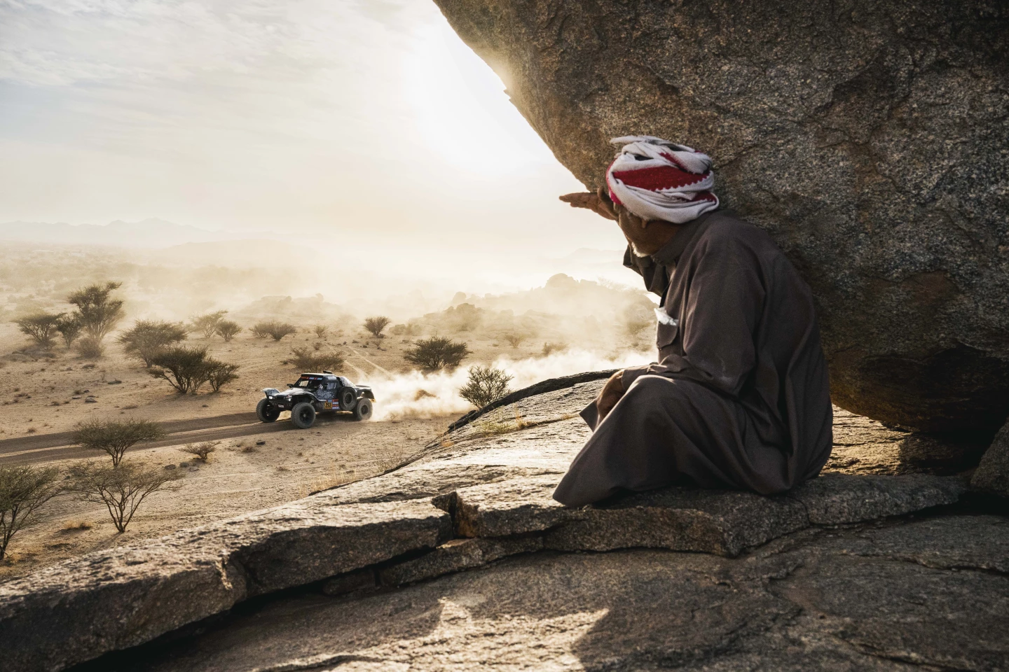 A local watches on as #253, Hugues Moilet and Oliver Imschoot, race by during the private test days leading up to the 2025 Dakar