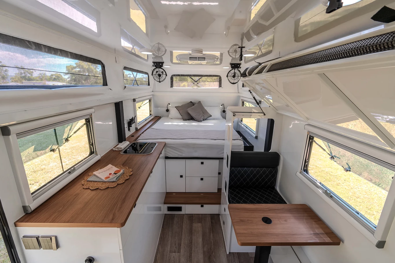 During the day, the top bunk folds away, and the bottom bunk turns into a vis-a-vis dinette