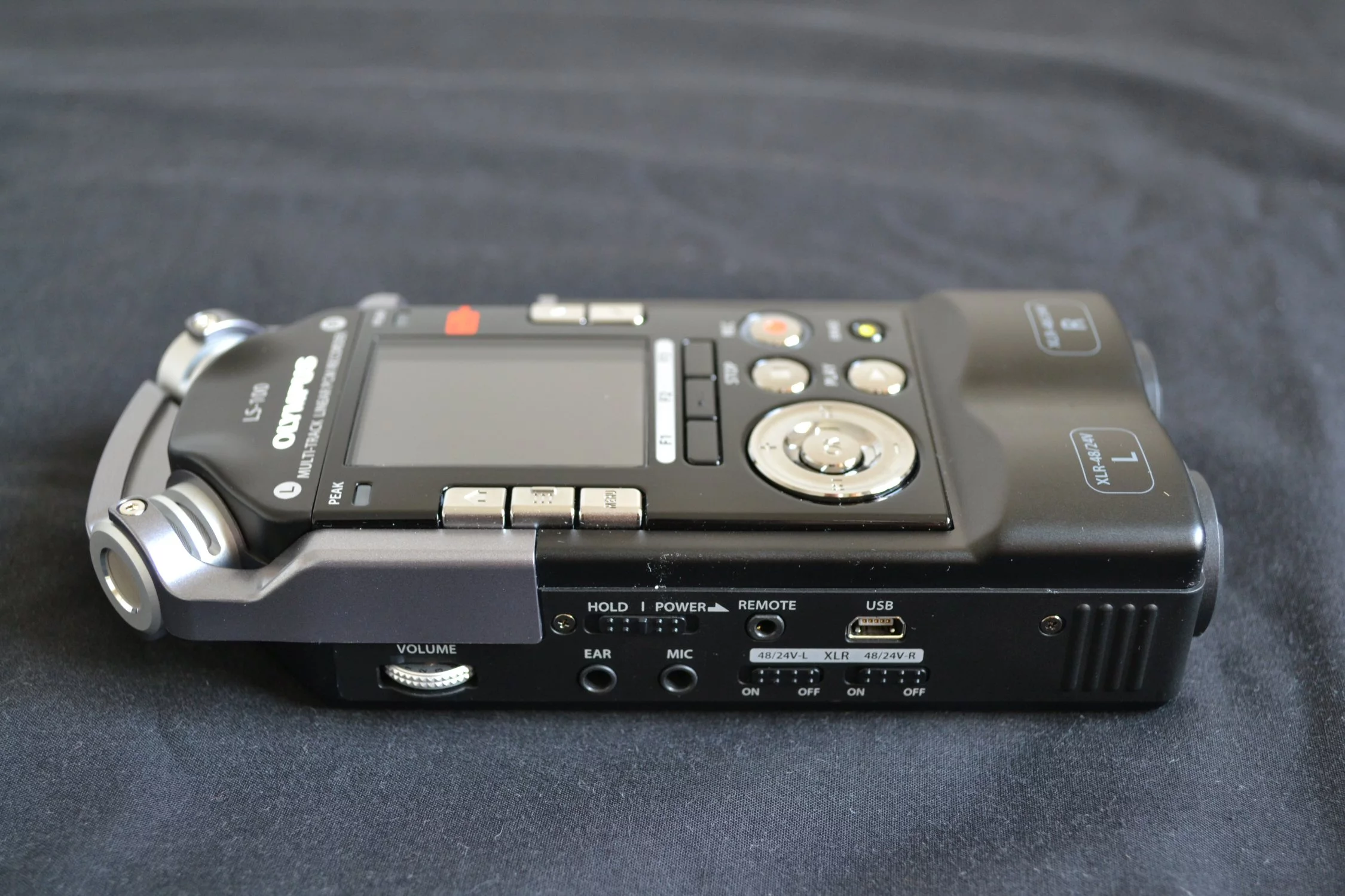 On the left, a 3.5 mm ear and mic inputs, a mini-USB port, the power/hold button, a volume wheel and phantom power for left and right XLR/Phone ports