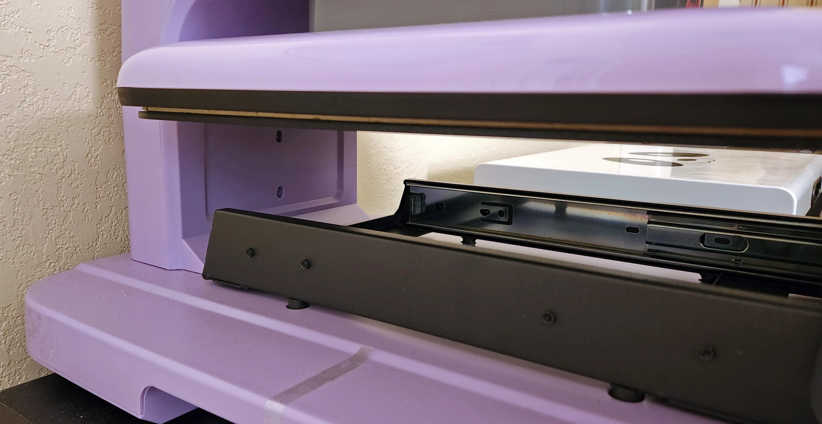 With the tray slid out, and looking at the rear area from the left, you can see how there's not a ton of space back there for extra fabric, like hoods on hoodies. I'd like to see that opened up a bit more