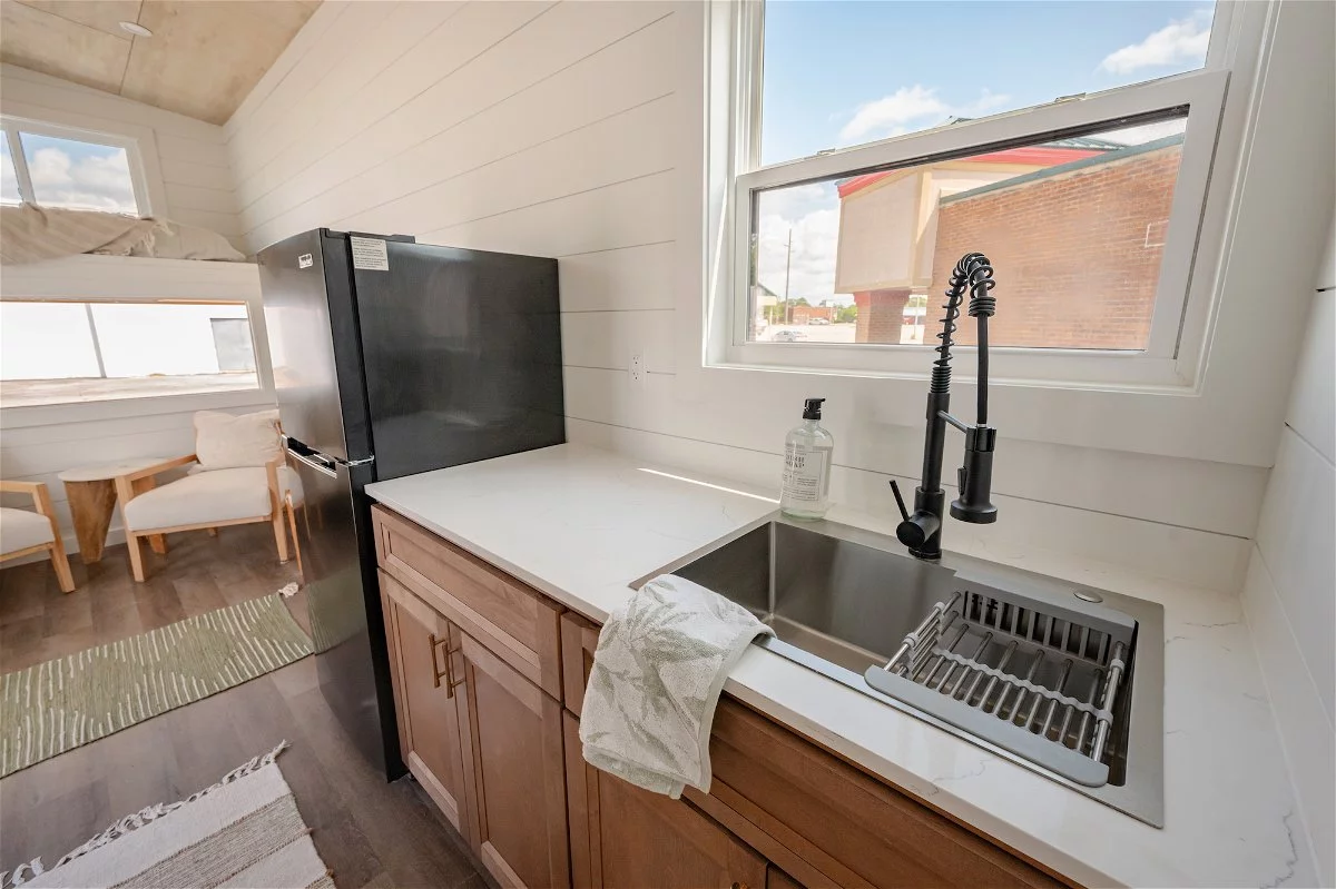 The Overlook's kitchen includes a sink, fridge, and space for a washing machine