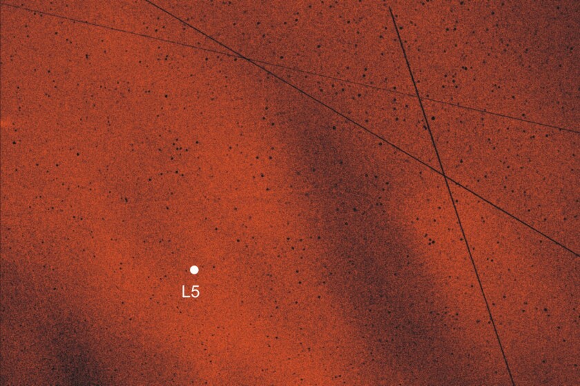 The bright red area indicates the concentration of dust particles in the area of Lagrange point L5