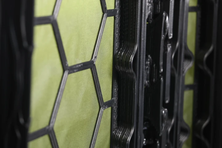 Each panel consists of the fabric base (green) and the 3D-printed structural grid (black)