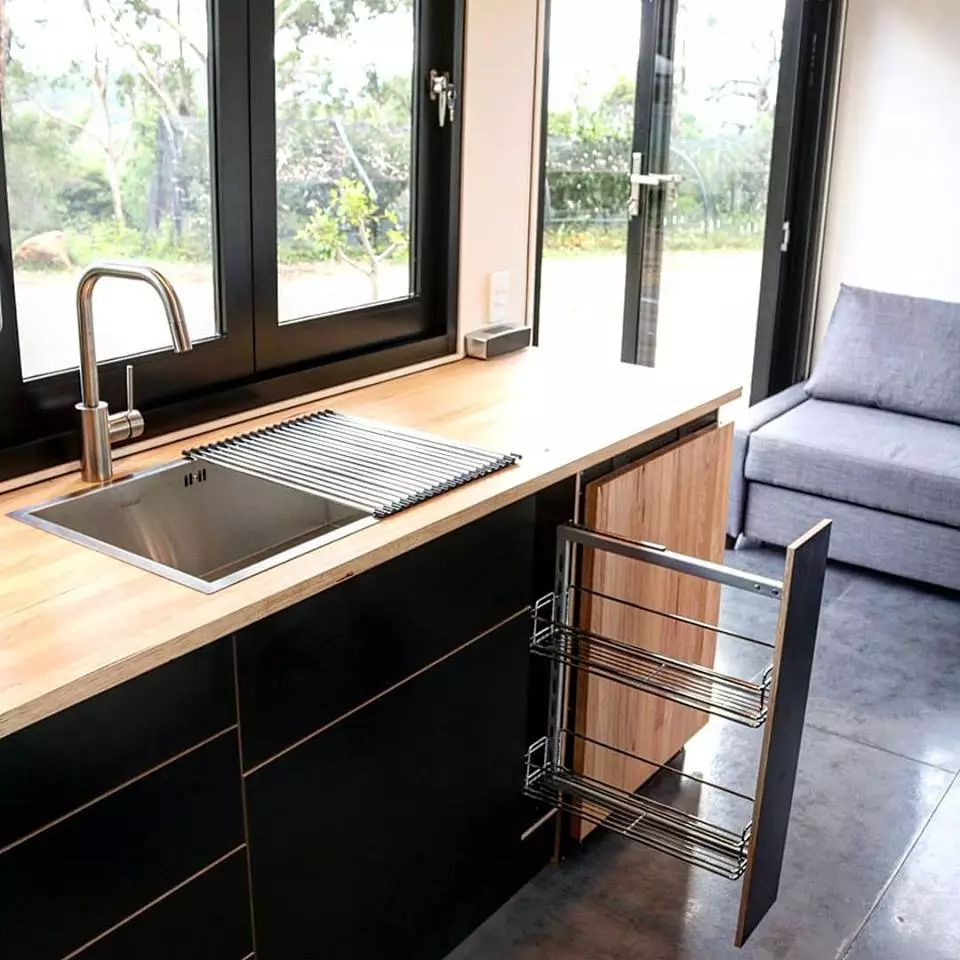 The full kitchen in the Sowelo tiny house features lots of storage and push-to-open drawers