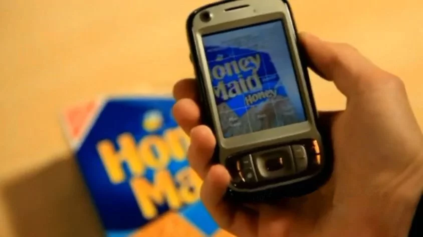 LookTel sends an image captured using a smartphone camera to software on a PC which searches through a database and then returns the result to the smartphone, where it is read out to the user