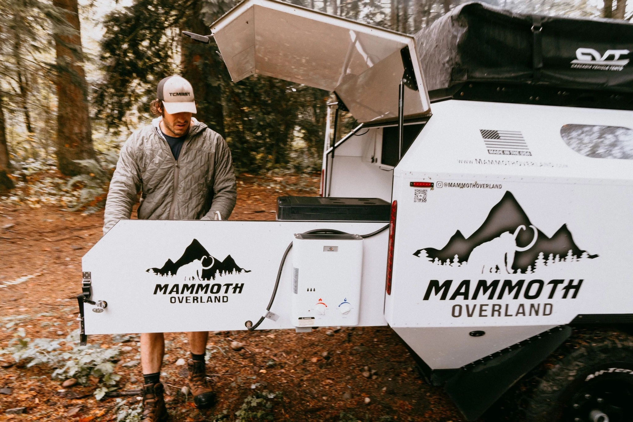 The hot water heater is mounted on the outside of the kitchen swing, and Mammoth lists a shower and privacy tent among its standard features
