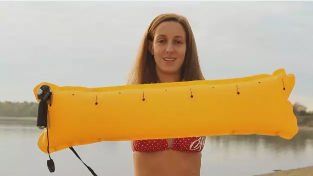 When the Restube inflates, the user holds onto it to keep afloat