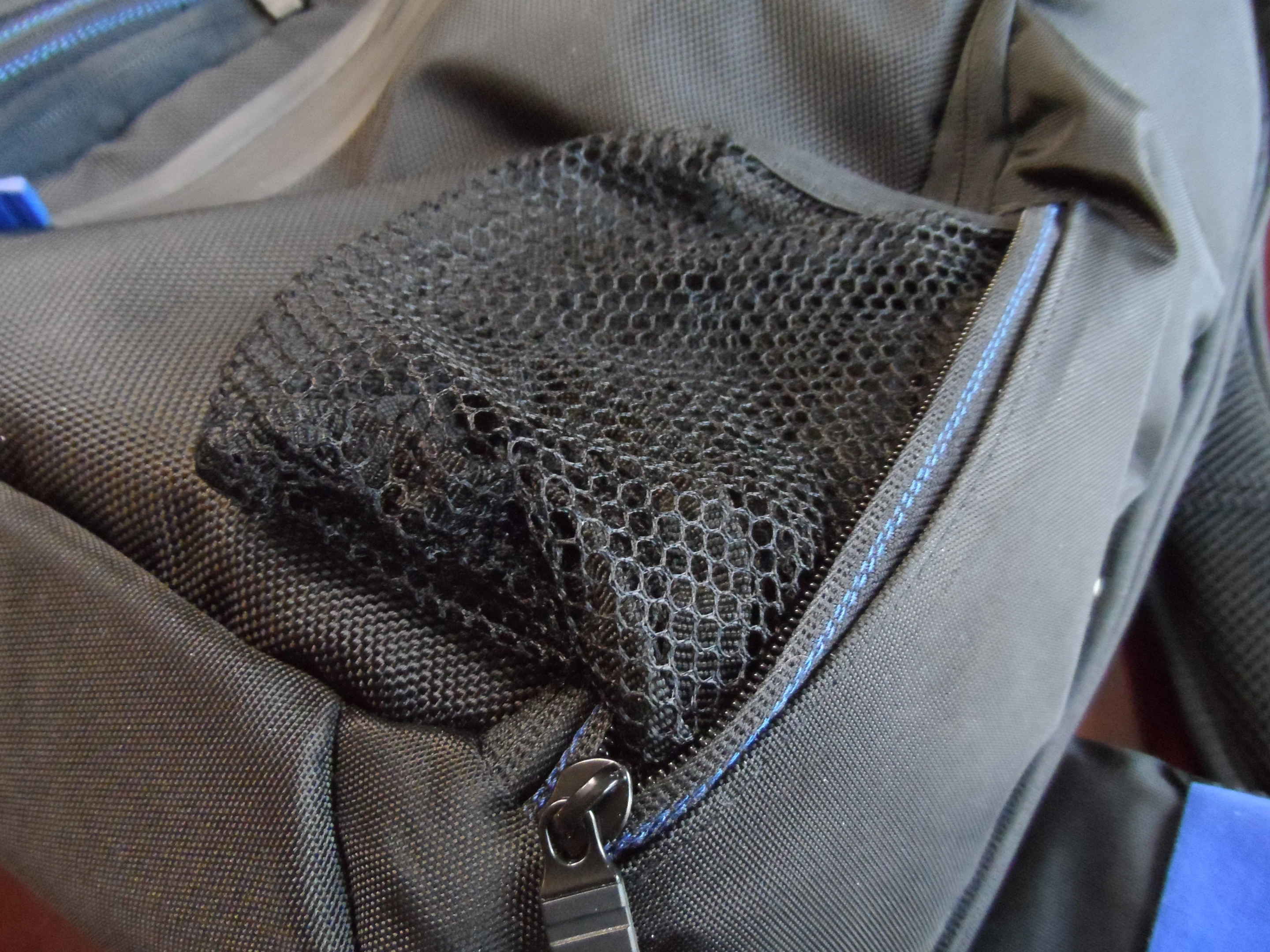 One of the front pouches features a pull-out drink holder