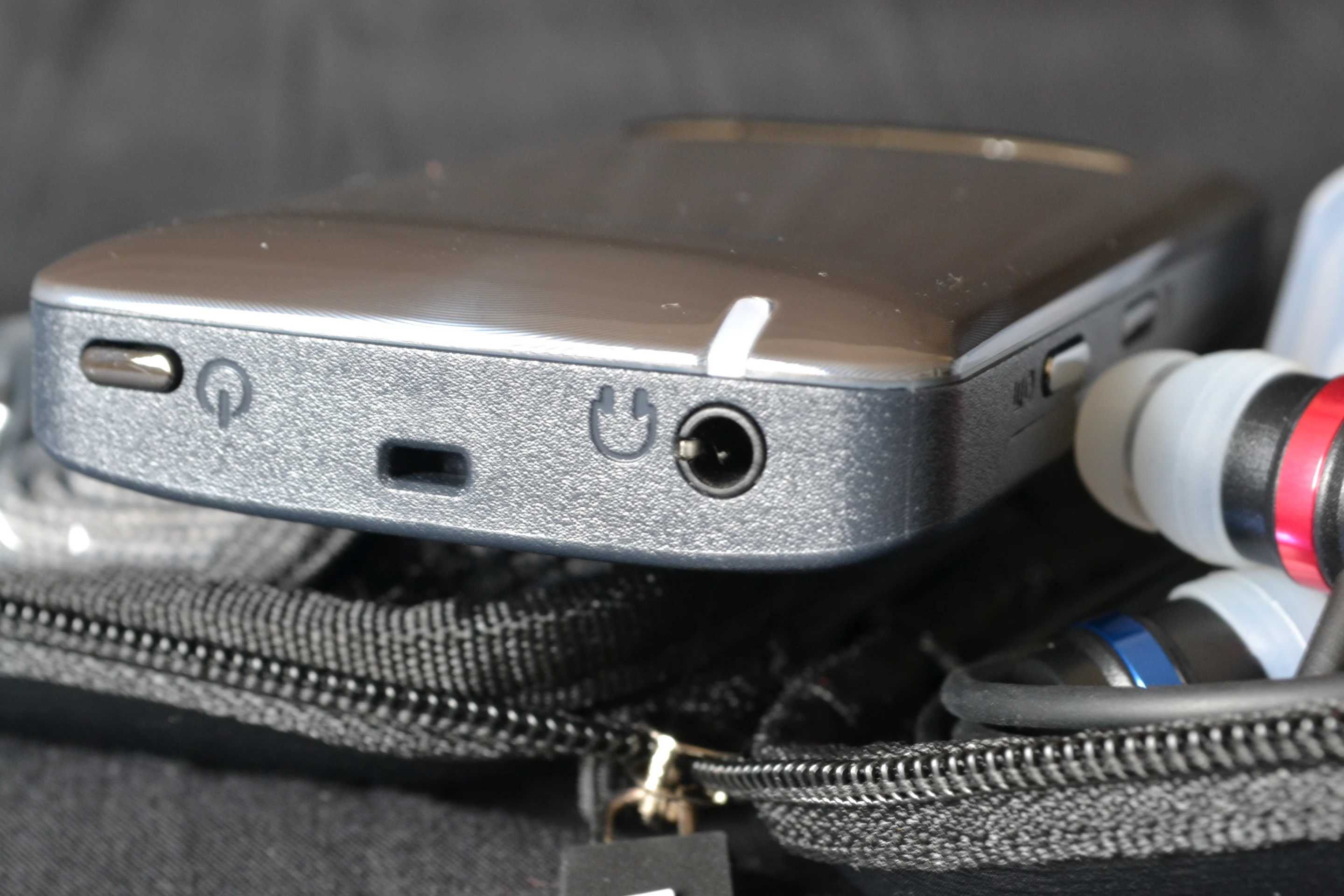 There's a power switch, neck loop hook and headphone jack to the top