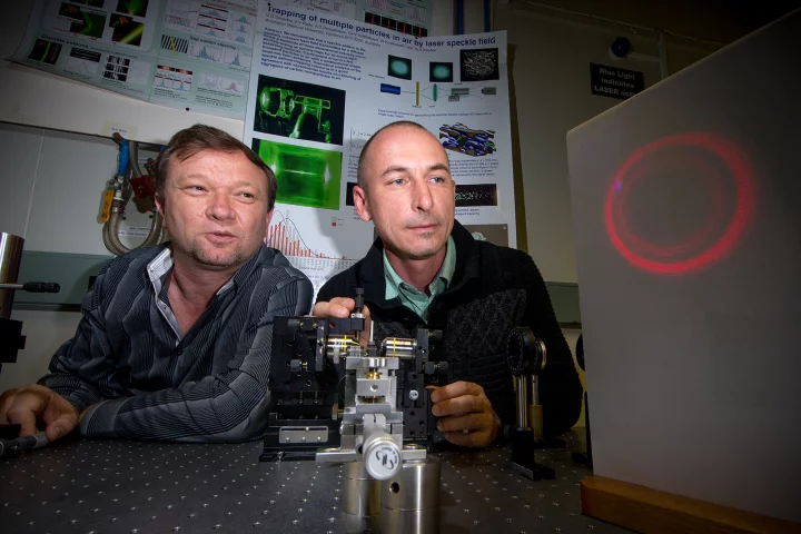 Dr Vladlen Shvedov (left) and Dr Cyril Hnatovsky (right) with a magnified projection of the "hollow" laser beam (Photo: Stuart Hay, ANU)