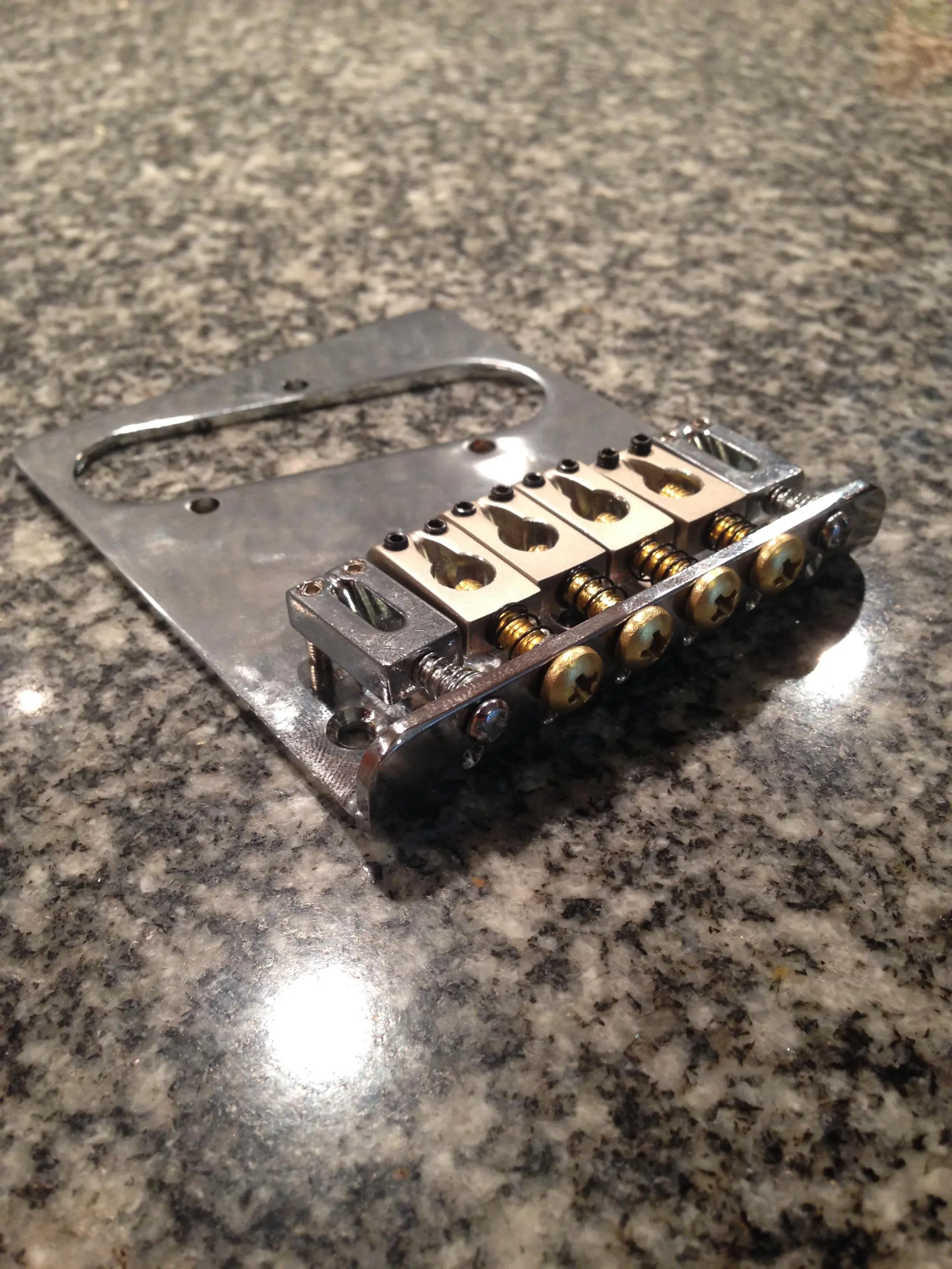 The A, D, G and B strings pass through the saddle screws on their way to the servos