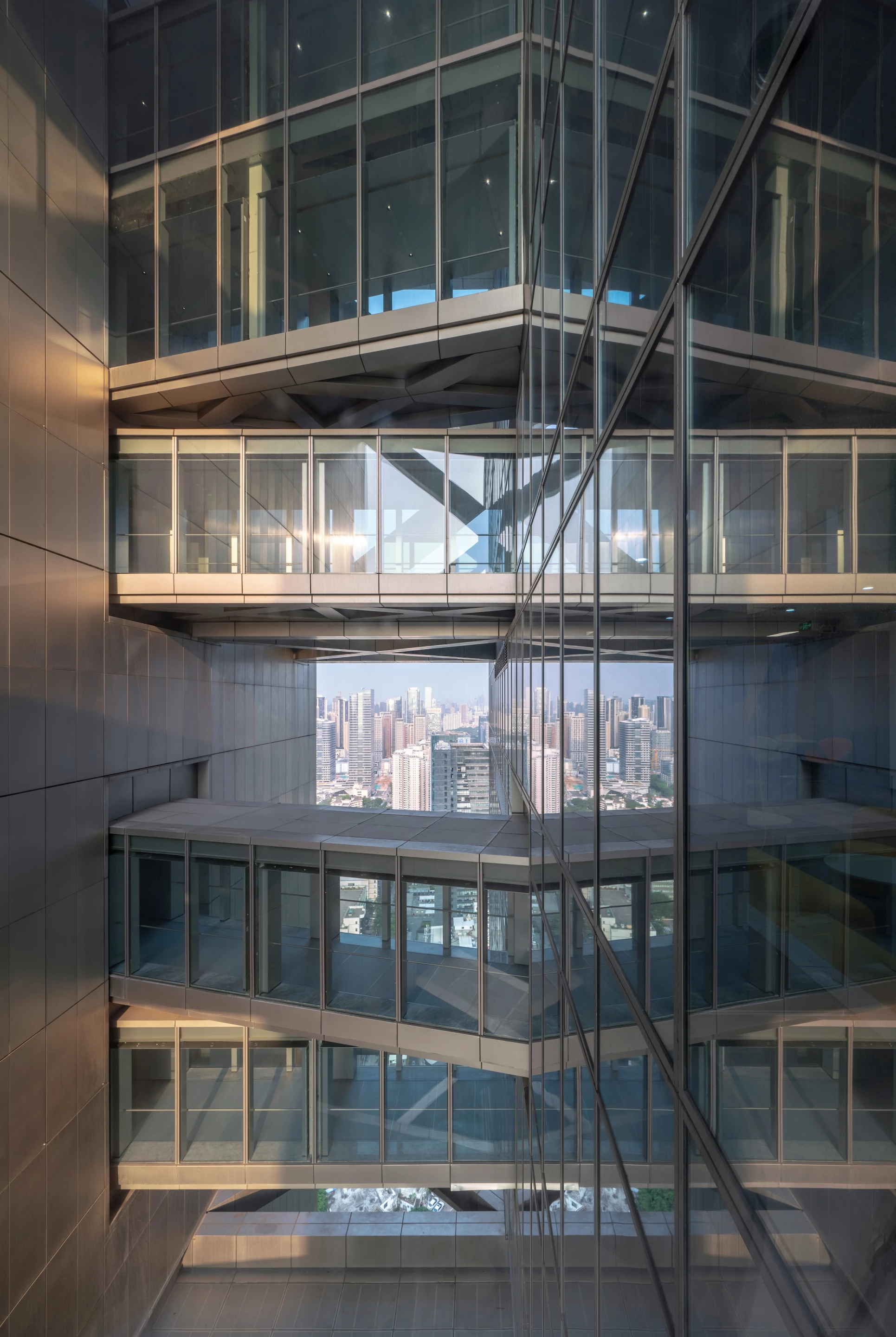 A series of skybridges and structural supports connect the main tower structure of Hanking Center to its detached core