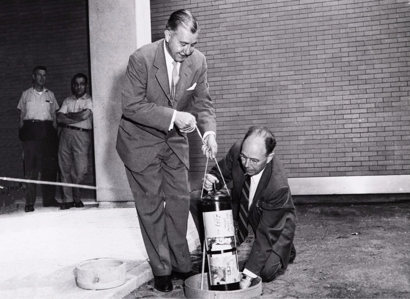 Killian Jr. (left) and Edgerton burying the time capsule