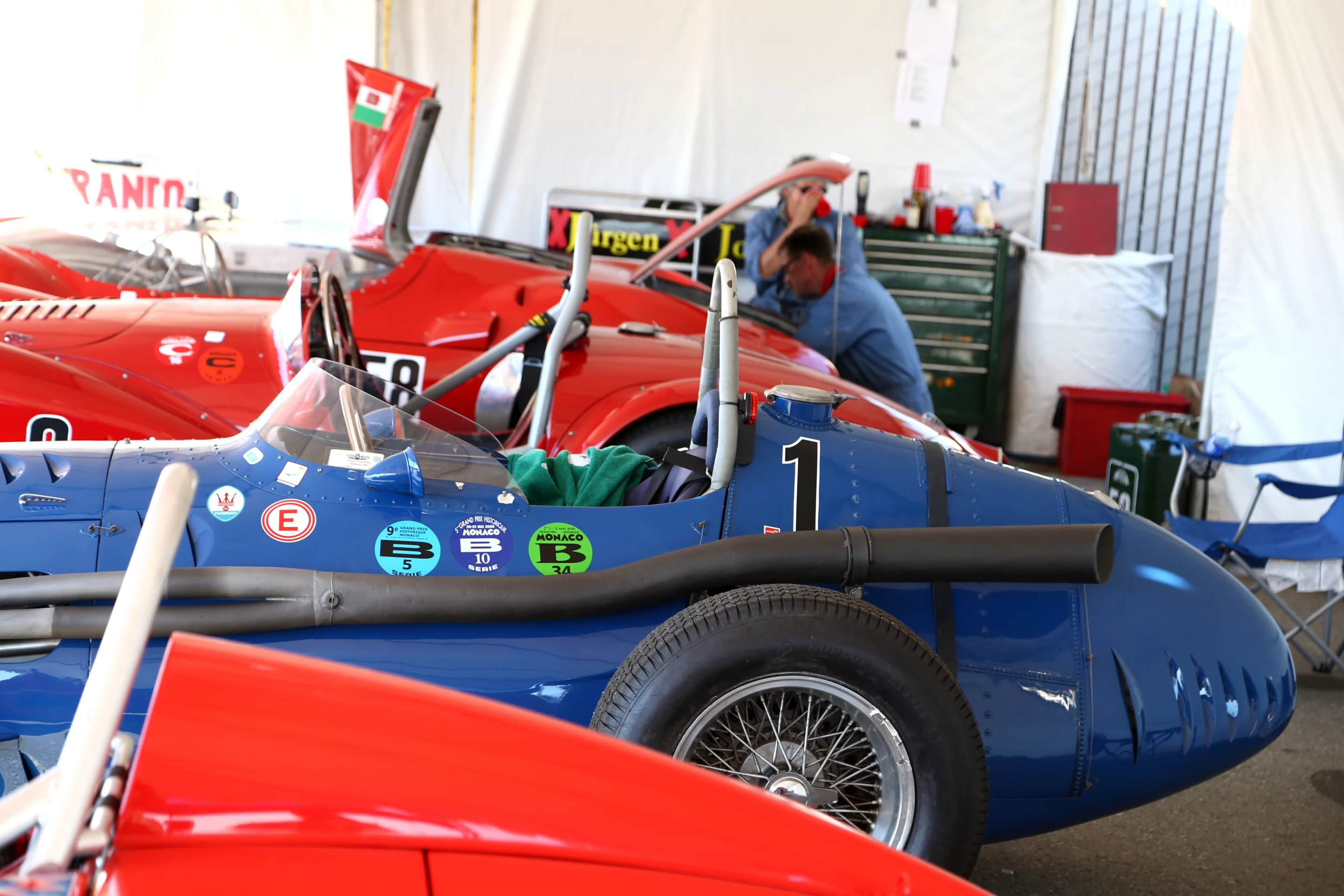 A Maserati 250F sits between other racers (Photo: Angus MacKenzie/Gizmag.com)