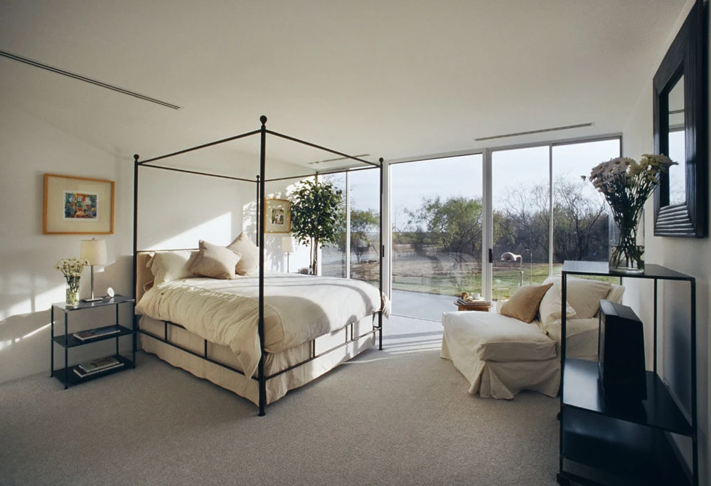 Large glass windows at the back of the house offer expansive views