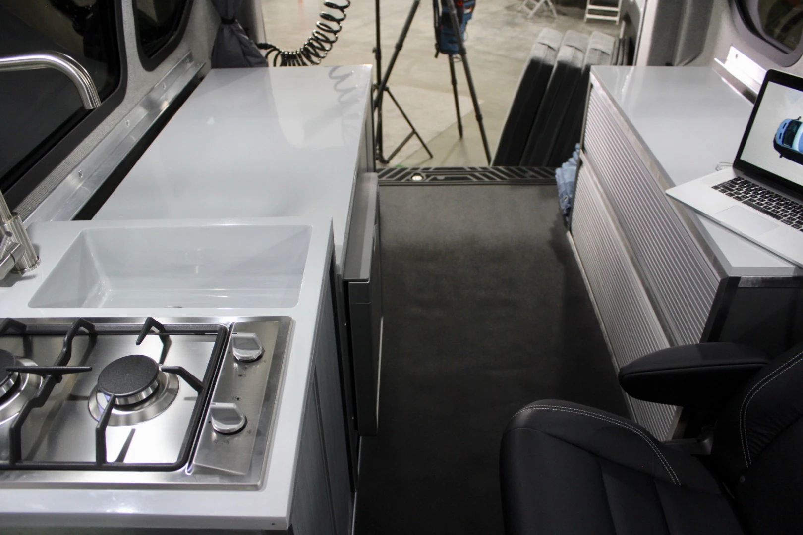A stowaway bed sets up atop the rear cabinets, allowing the CV1 to sleep four adults on its upper and lower beds