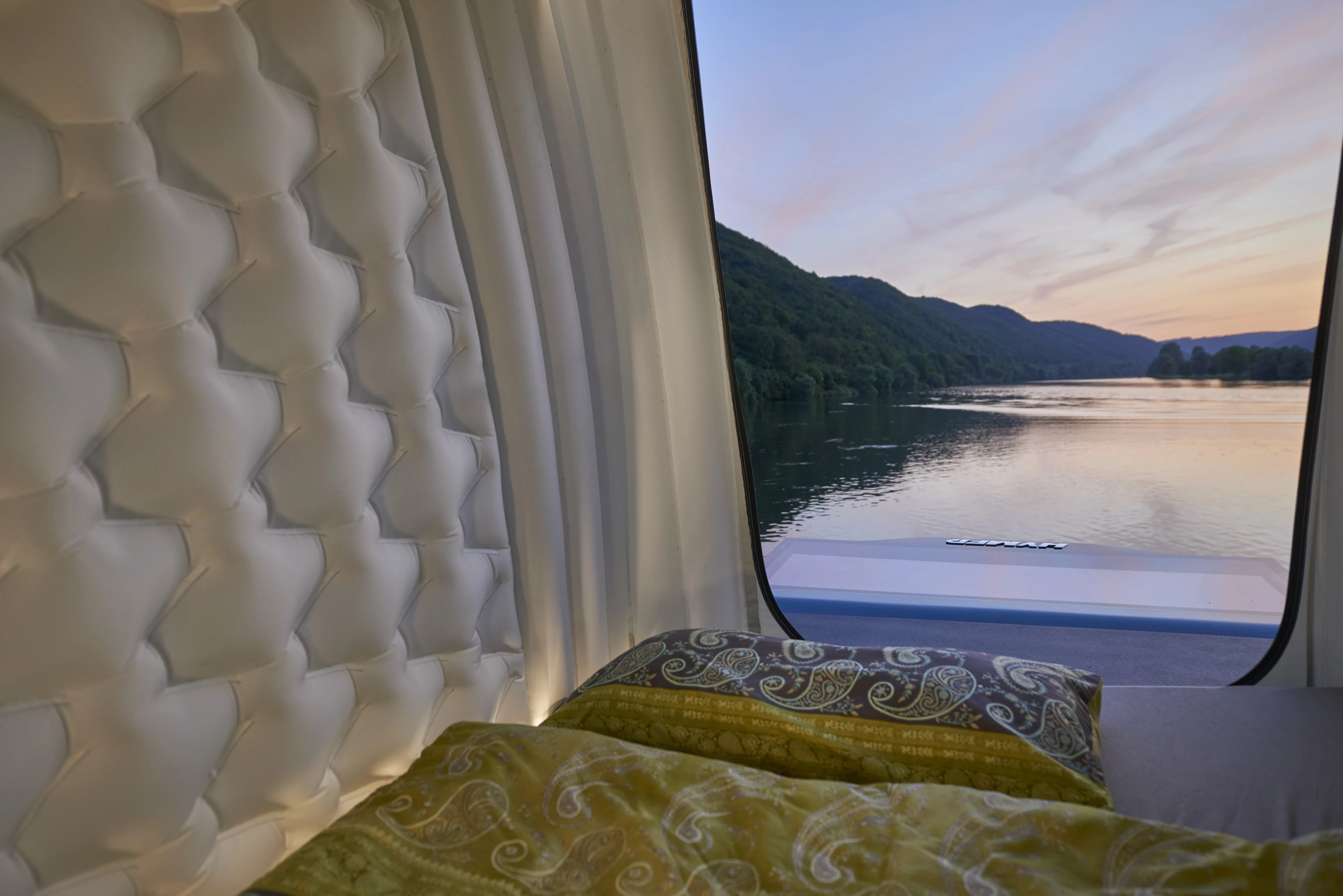 Campers can enjoy views out the large pop-top door and even scoot out onto the back of the roof, which serves as a small upper deck