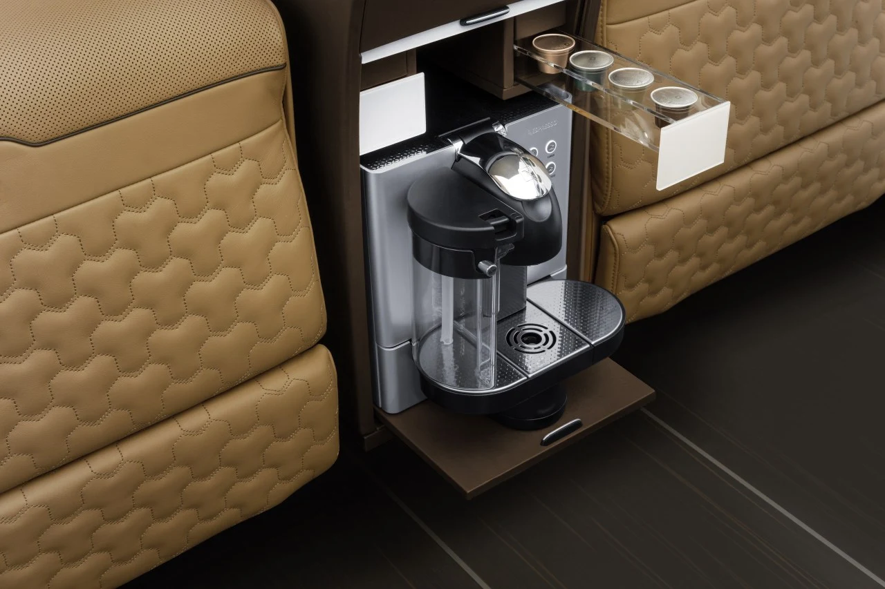 The center console in the passenger cabin includes a coffeemaker