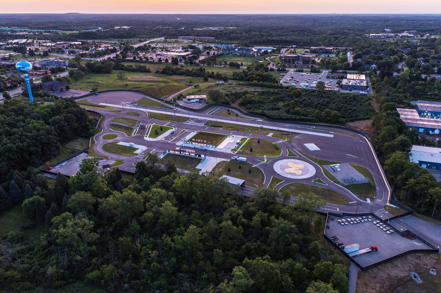 An aerial view of Mcity shows some of its varied road surfaces, including a large roundabout (the M) and a freeway "onramp"
