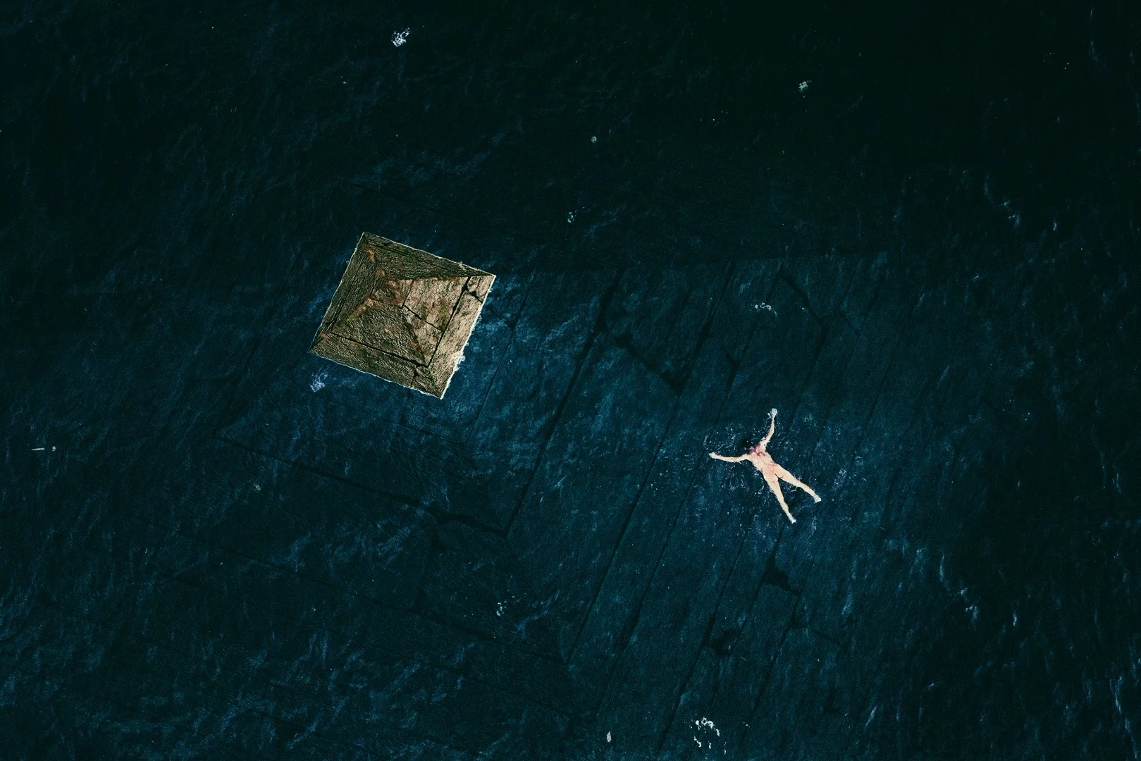 A composition of an aerial photo and a 3d pyramid