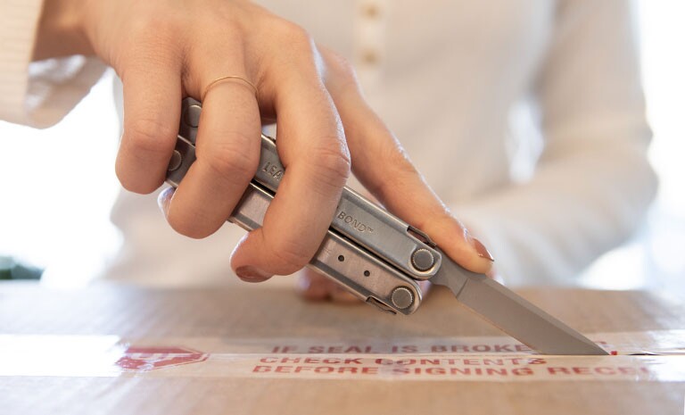 The Leatherman Bond in action as a box cutter