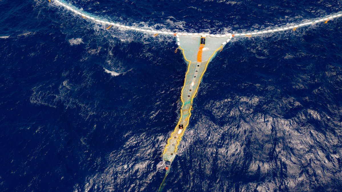 The Ocean Cleanup Project's new trash-catching barriers funnel waste into a retention zone at the far end