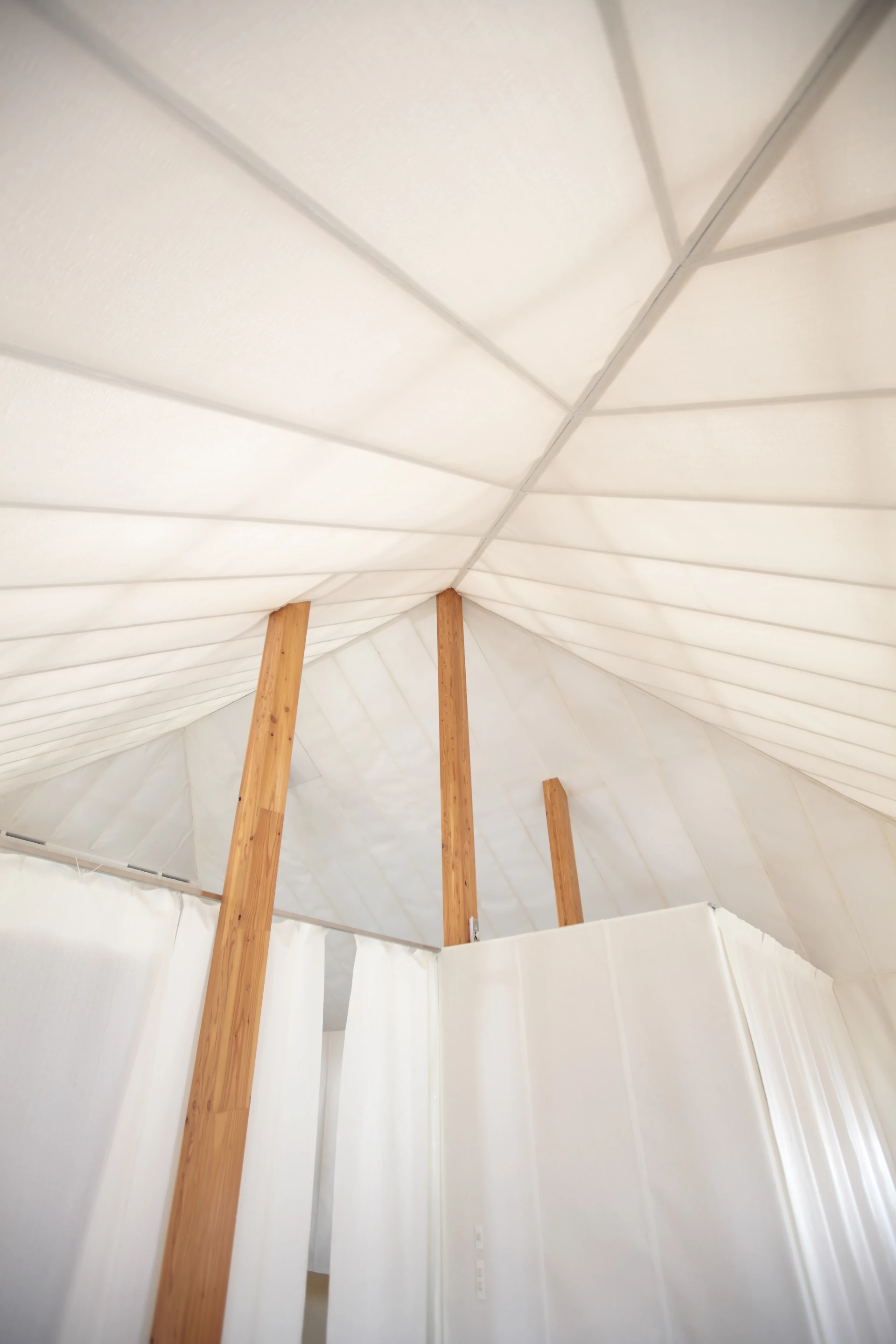 The tented interior show the timber supports made from local larch wood (Photo: Kengo Kuma Associates, from the forthcoming book "Superlight")