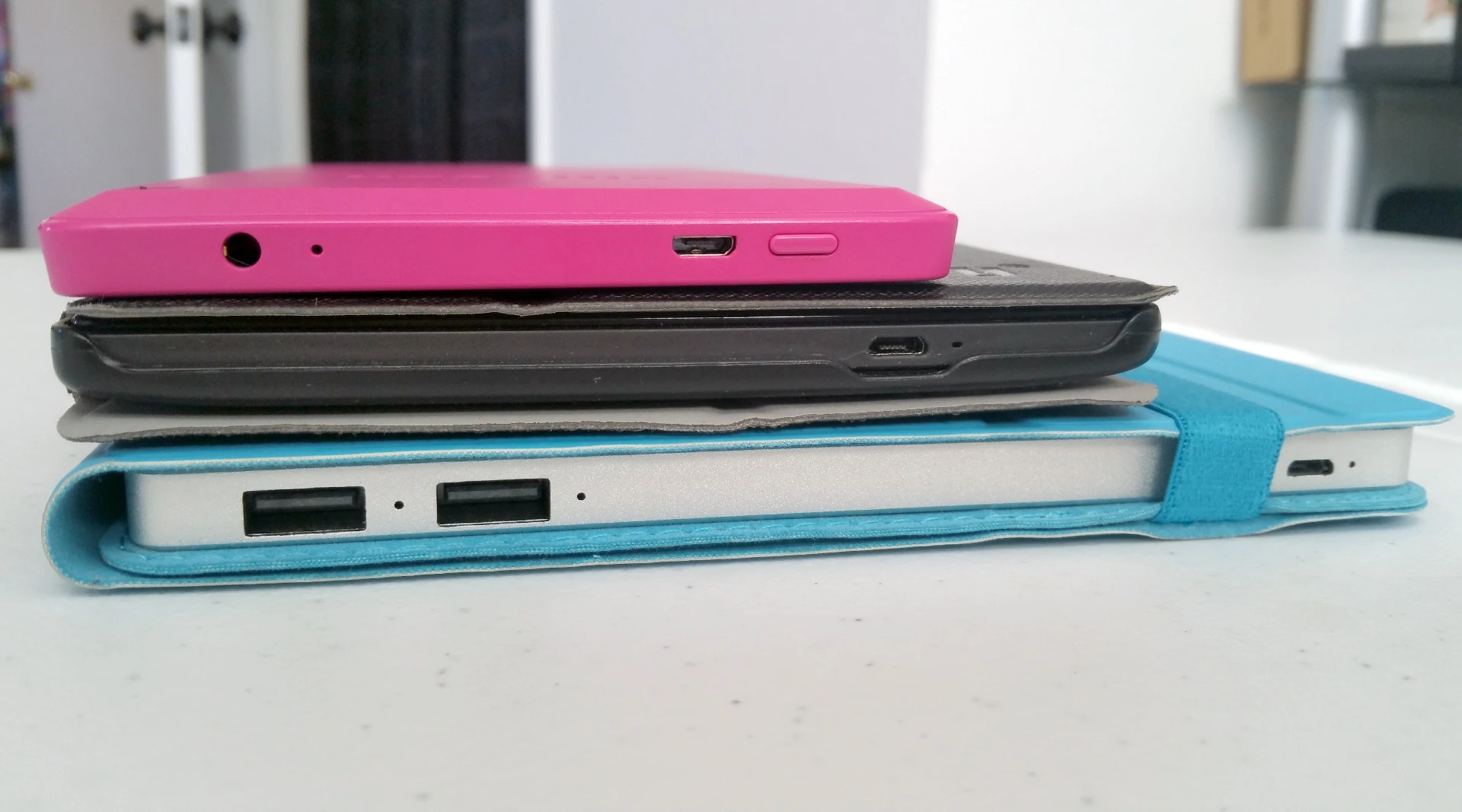 The Solartab's (bottom) design makes it a convenient companion with mobile devices, such as the Lenovo S8-50 (middle) or Kindle Fire HD6 (top)