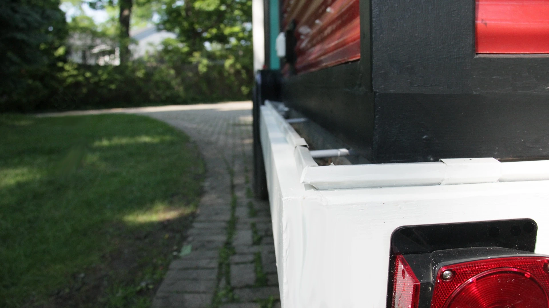 A grey water recycling system sends used water into a trough around the base of the house that contains plants