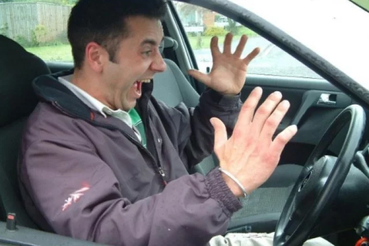 This man appears to be annoyed by interior buzzing sounds in his car. We suggest he gets a Rattlebuster post-haste.