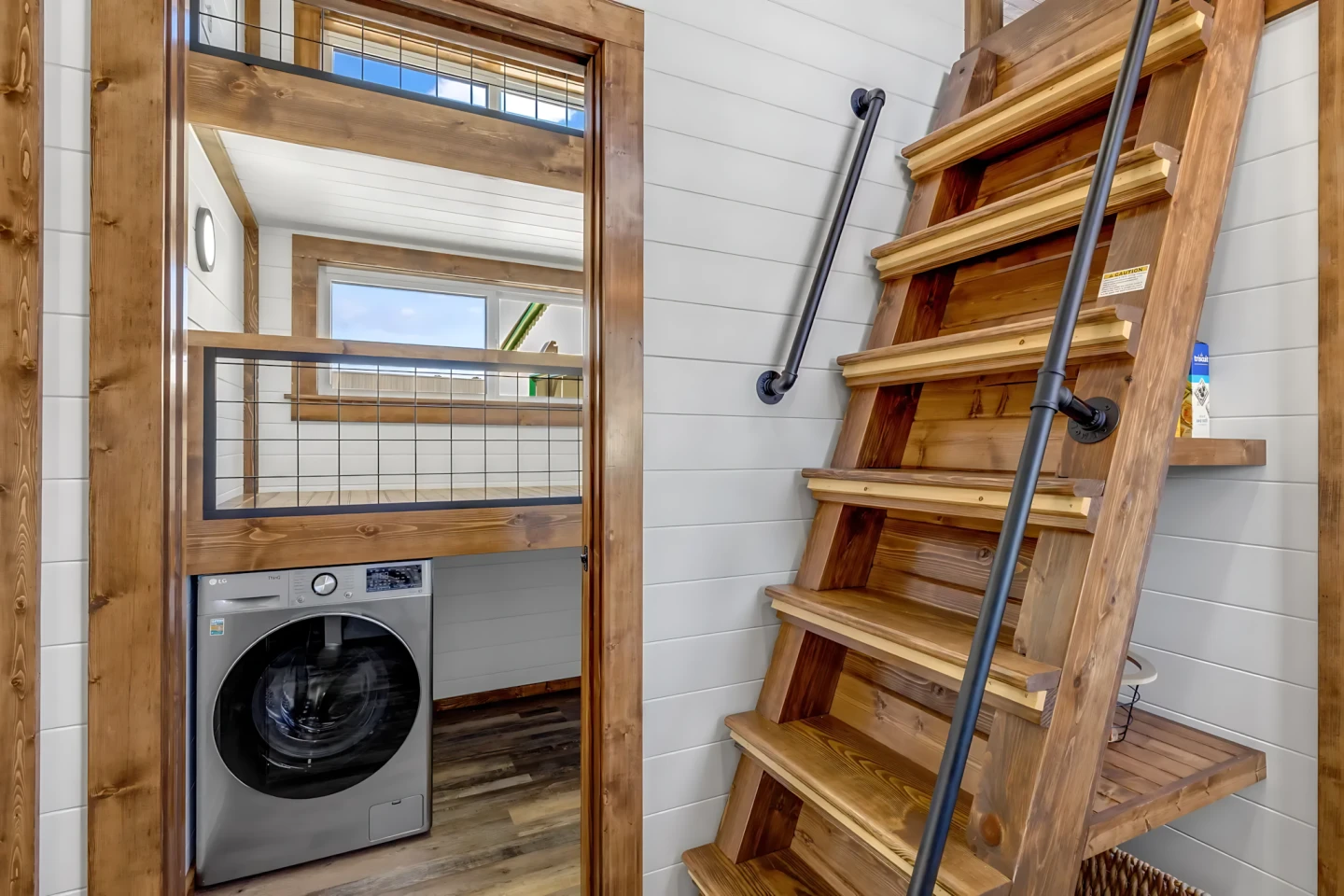 The Tinde's bonus room is shown here with a washer/dryer and raised sleeping area