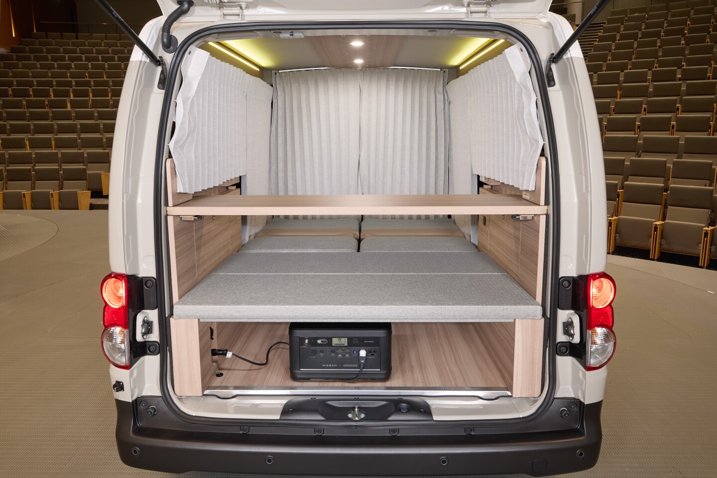 Sleeper configuration with available curtains, optional power station and table set up for a possible breakfast in bed