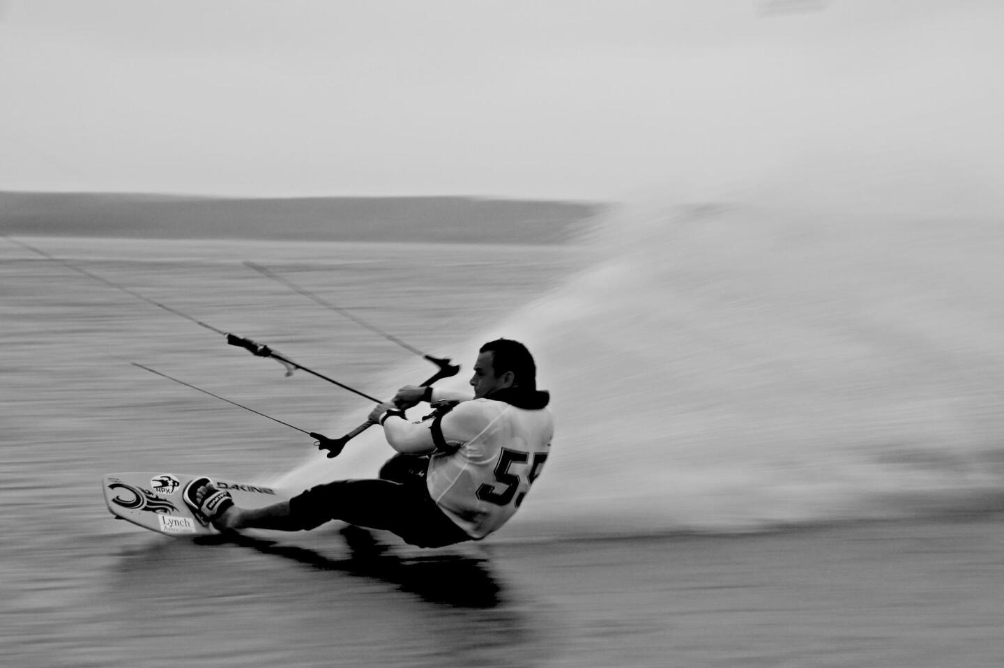 The fastest kitesurfer in the world (US-55 - Robbie Douglas) is also the proprietor of Black Dog Clothing Company. From his Facebook page.