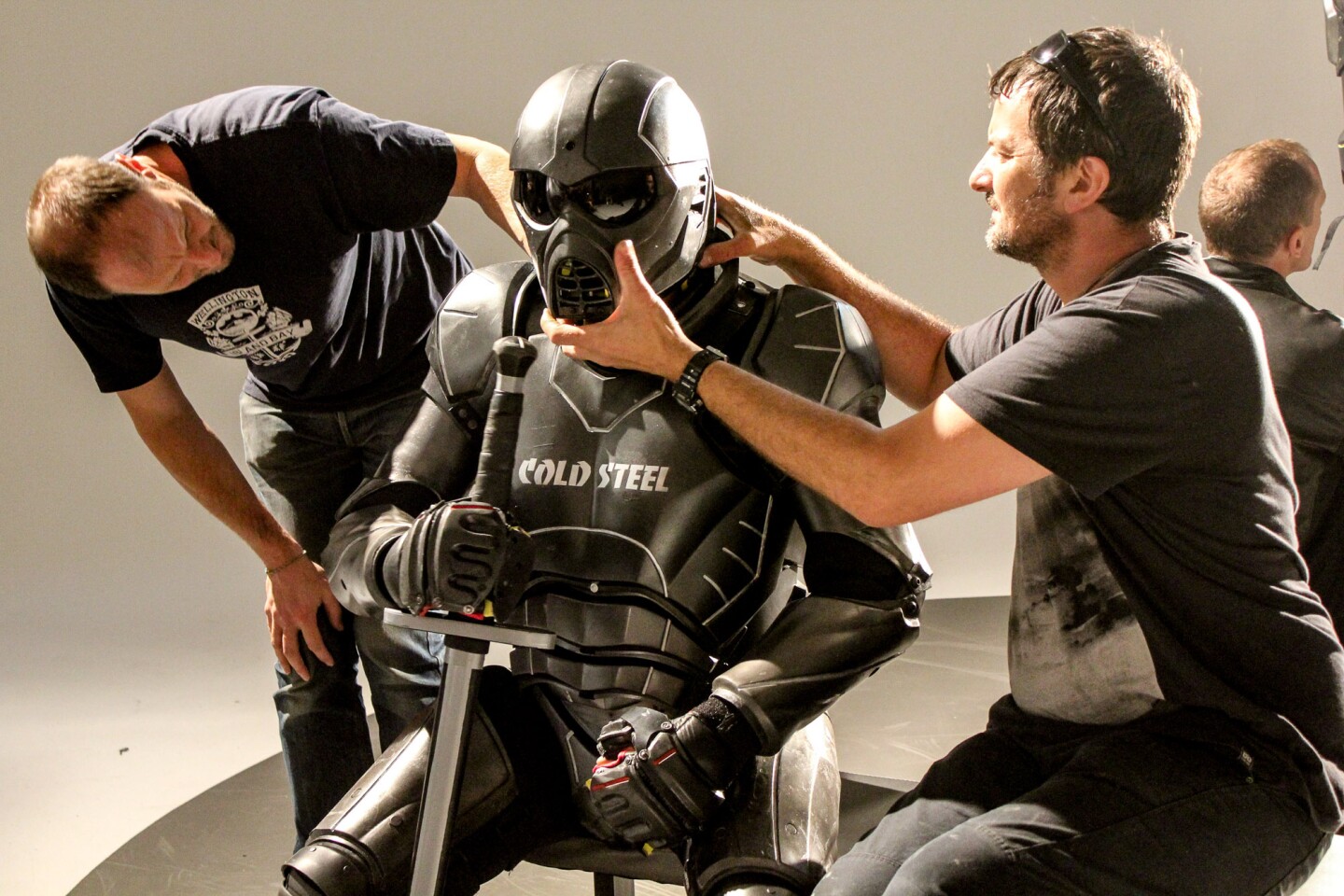 UWM: team assists fighter to put his helmet on