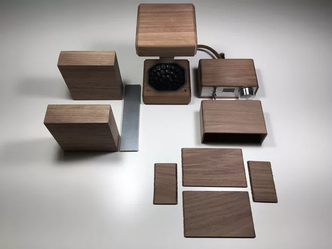 The device is crafted in stylish walnut wood casings